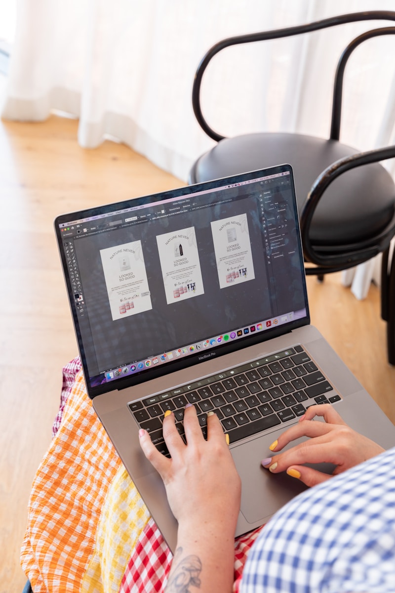 a person sitting in a chair using a laptop computer